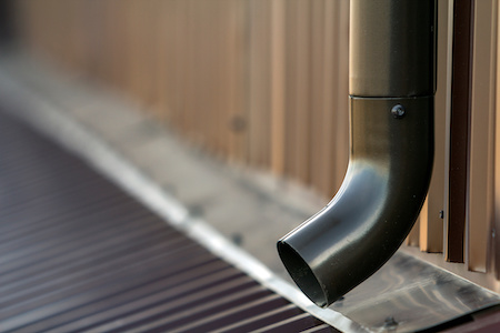 Brown New Gutter Metal System Pipe. Vertical Construction For Draining Rain Water From Building Roof On The Wall. Drain Protection.