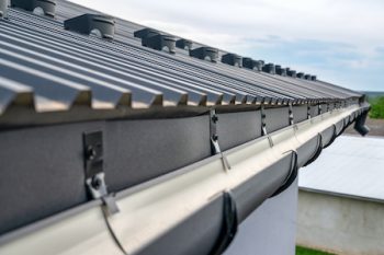 . Gutter System For A Metal Roof. Holder Gutter Drainage System On The Roof.
